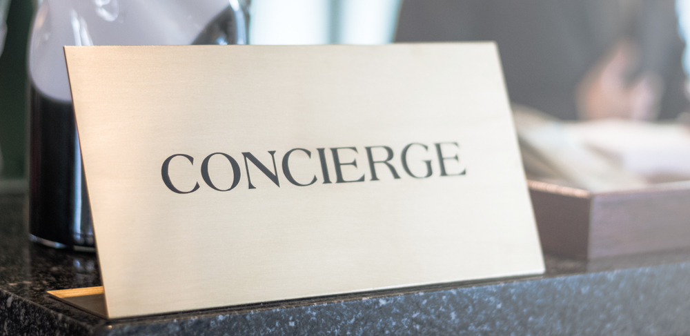 Elegant concierge service desk with gold signage