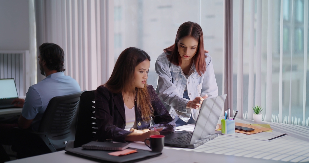 Administrative team collaborating on tasks in modern office