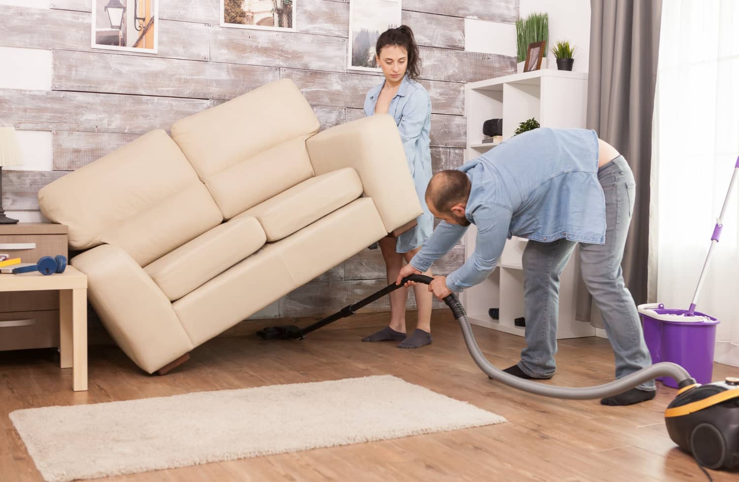 Deep vacuuming under furniture during thorough move-out clean